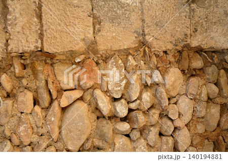 Golden masonry stone wall from old building Golden masonry stone wall from old building 140194881