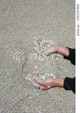 gravel rolling stones falling man hands in quarry background gravel rolling stones falling man hands in quarry background 140194904