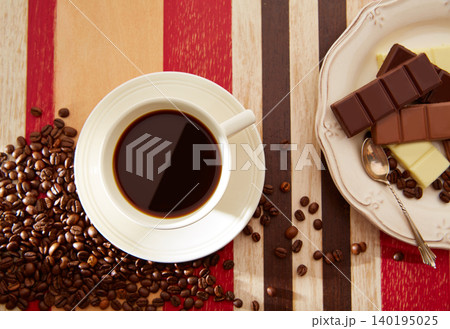 Coffee cup with chocolate and coffee beans Coffee cup with chocolate and coffee beans 140195025