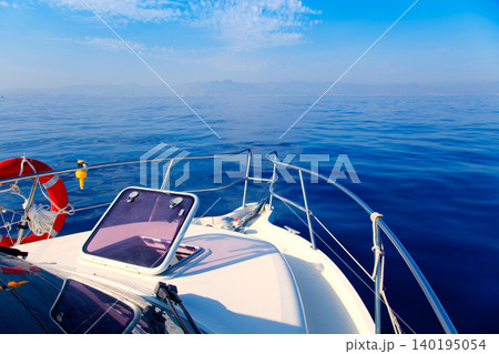 Blue sea boat sailing with open bow porthole 140195054