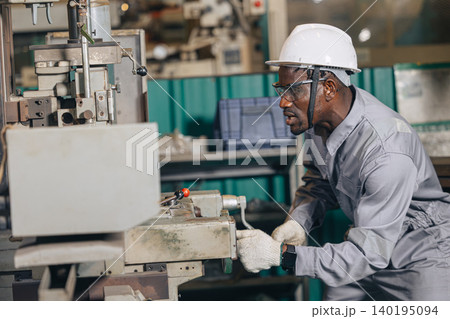 Engineer technician worker using Surface Grinding machine working in heavy metal industry Engineer technician worker using Surface Grinding machine working in heavy metal industry 140195094