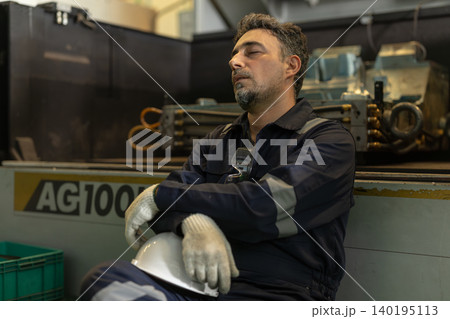 Mature Adult Engineer Worker male rest nap at workplace Tired Fatigue Exhausted from hard work 140195113