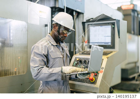 Professional African black worker, Engineer male working control CNC machine in industry factory Professional African black worker, Engineer male working control CNC machine in industry factory 140195137