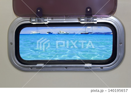 Boat porthole turquoise tropical blue ocean sea Boat porthole turquoise tropical blue ocean sea 140195657