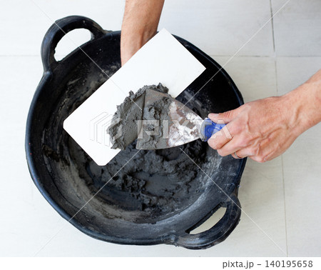 contruction mason worker hands with cement mortar contruction mason worker hands with cement mortar 140195658