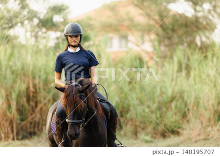 Horsewoman riding sport animal, Horseback rider. Girl teen ride horse happy fun in stable horse farm Horsewoman riding sport animal, Horseback rider. Girl teen ride horse happy fun in stable horse farm 140195707