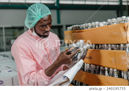 African Black male worker in food and drinks factory with hygiene food safety standard uniform African Black male worker in food and drinks factory with hygiene food safety standard uniform 140195735