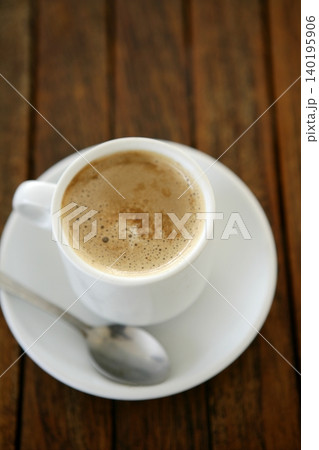 Coffe with milk white cup over teak wooden 140195906