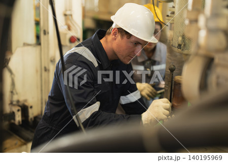 Male worker service machine, Engineer man working in heavy industry servicing machine in plant factory Male worker service machine, Engineer man working in heavy industry servicing machine in plant factory 140195969