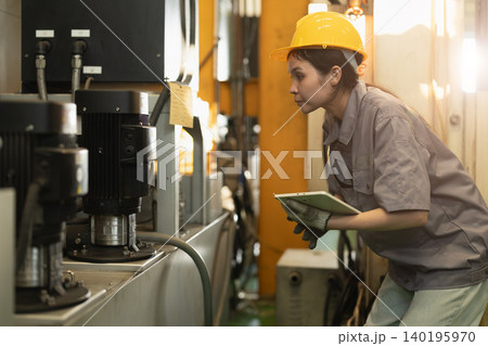 Women worker, Engineer woman hard working in heavy industry service machine in plant factory Women worker, Engineer woman hard working in heavy industry service machine in plant factory 140195970