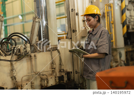 Women worker, Engineer woman hard working in heavy industry service machine in plant factory Women worker, Engineer woman hard working in heavy industry service machine in plant factory 140195972
