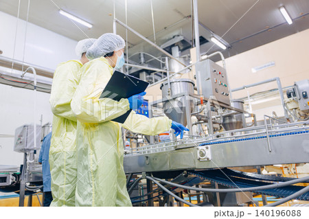 Food hygiene inspector team work examination food production process in line at cannery food factory Food hygiene inspector team work examination food production process in line at cannery food factory 140196088