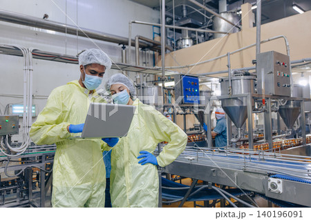 Food hygiene inspector team work examination food production process in line at cannery food factory Food hygiene inspector team work examination food production process in line at cannery food factory 140196091