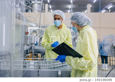 Food hygiene inspector team work examination food production process in line at cannery food factory Food hygiene inspector team work examination food production process in line at cannery food factory 140196096