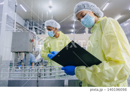 Food hygiene inspector team work examination food production process in line at cannery food factory 140196098