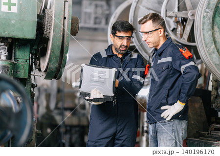 Professional Technician engineer assist team work maintenance service old metal machine in plant Professional Technician engineer assist team work maintenance service old metal machine in plant 140196170