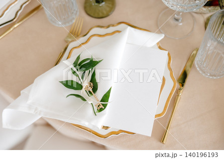 Elegant Place Setting with Gold Key and Blank Card on White Plate Elegant Place Setting with Gold Key and Blank Card on White Plate 140196193