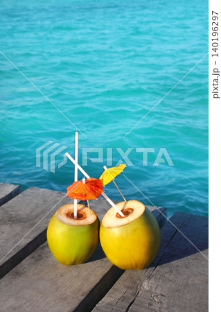 coconut coktails in caribbean on wood pier coconut coktails in caribbean on wood pier 140196297