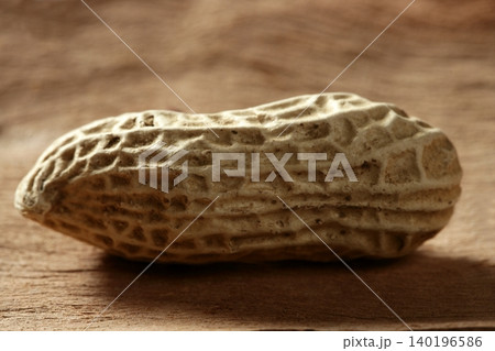 Peanuts macro over wood background Peanuts macro over wood background 140196586