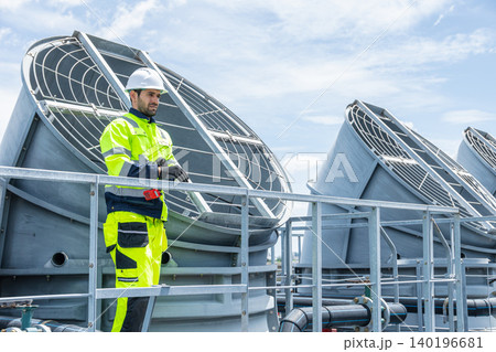 Professional Worker Servicing HVAC building cooling tower, Industry air conditioner service Professional Worker Servicing HVAC building cooling tower, Industry air conditioner service 140196681