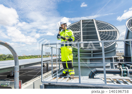 Professional Worker Servicing HVAC building cooling tower, Industry air conditioner service 140196758