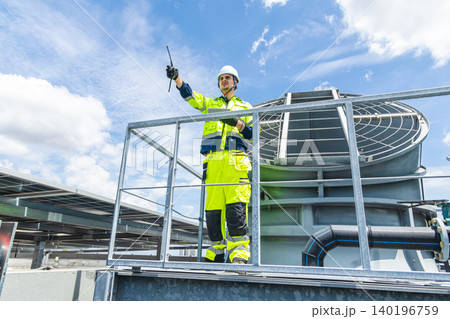 Professional Worker Servicing HVAC building cooling tower, Industry air conditioner service 140196759