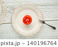 cut half tomato in white plate minimalist food 140196764