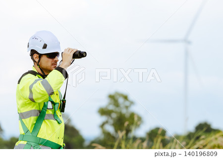 engineer male working outdoor survey at wind turbines clean energy power station background. 140196809