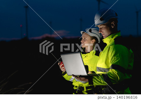 Professional engineer team at night shift. Workers in wind turbine. Technician work survey inspector Professional engineer team at night shift. Workers in wind turbine. Technician work survey inspector 140196816