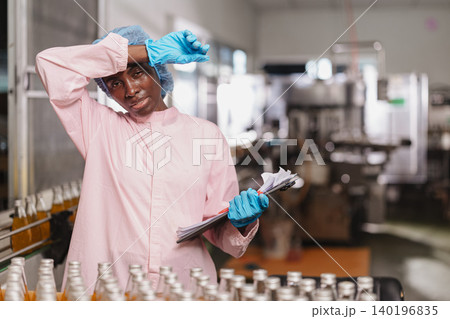 African Black Woman Worker works in Food and drinks factory feel Tired Exhausted and Sweating African Black Woman Worker works in Food and drinks factory feel Tired Exhausted and Sweating 140196835