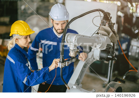 Engineer woman team worker work in Machine Robotic modern Automation Industry. Mechanic staff employee in metal factory. Engineer woman team worker work in Machine Robotic modern Automation Industry. Mechanic staff employee in metal factory. 140196926