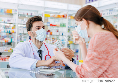 Pharmacy doctor selling medicine to sick women suggest health consult to select right good medicine in drugstore. Pharmacy doctor selling medicine to sick women suggest health consult to select right good medicine in drugstore. 140196927