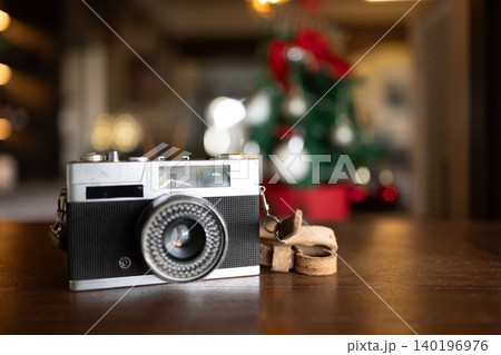 closeup vintage classic compact film camera, Vintage camera rests on wooden table 140196976