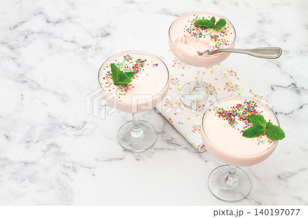 fruit mousse, made from jelly and cottage cheese, in glasses, decorated with sprinkles and mint, homemade 140197077