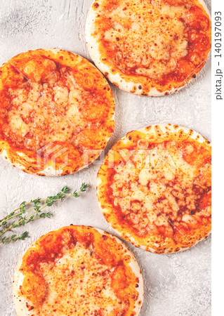 Four pizzetta Margaritas, on a light grey surface, top view, 140197093