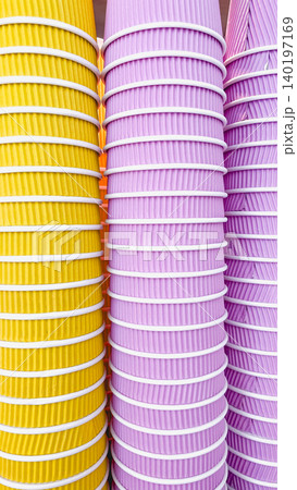 Abstract pattern of stacked yellow and purple ripple paper cups for takeaway coffee 140197169