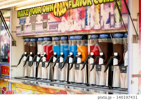 Row of slushie machines with multi-colored frozen drinks at a festival food concession trailer Row of slushie machines with multi-colored frozen drinks at a festival food concession trailer 140197431