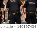 police officers in black uniforms walk down the street during the Stampede Parade in Calgary. 140197434
