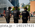 police officers in black uniforms walk down the street during the Stampede Parade in Calgary. 140197435