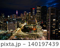 The scene shows Calgary's skyline at night with illuminated buildings and the iconic Calgary Tower. City lights shine against the dark sky. The view captures urban life and architecture 140197439