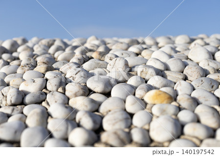 White Pebbles against Blue Sky with Selective Focus White Pebbles against Blue Sky with Selective Focus 140197542