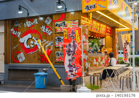 Osaka, Japan - Sep 21 2024, Panoramic view of the street cafe, street food, where takoyaki, a national Japanese dish, is prepared, at daytime, Osaka, Japan Osaka, Japan - Sep 21 2024, Panoramic view of the street cafe, street food, where takoyaki, a national Japanese dish, is prepared, at daytime, Osaka, Japan 140198176