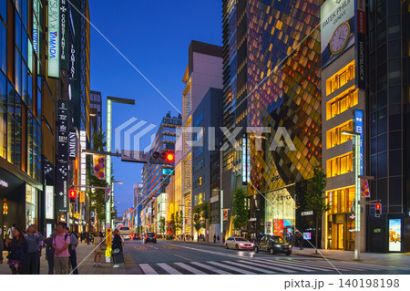 Tokyo, Japan - Oct 14 2024, A panoramic view of street in Ginza district with cars driving along road with their headlights on, facades of skyscrapers are full of lights and signs of various shops, a Tokyo, Japan - Oct 14 2024, A panoramic view of street in Ginza district with cars driving along road with their headlights on, facades of skyscrapers are full of lights and signs of various shops, a 140198198