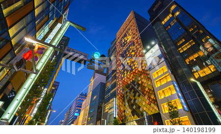 Tokyo, Japan - Oct 14 2024, A panoramic view from below of street in Ginza district, facades of skyscrapers are full of lights and signs of various shops, at evening with illuminations, Tokyo, Japan Tokyo, Japan - Oct 14 2024, A panoramic view from below of street in Ginza district, facades of skyscrapers are full of lights and signs of various shops, at evening with illuminations, Tokyo, Japan 140198199