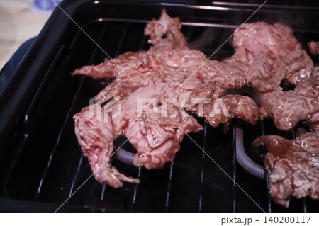 Grilling Raw Meat on a Grill Grilling Raw Meat on a Grill 140200117