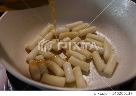 Syrup Drizzled Over Cooking Rice Cakes in Pan Syrup Drizzled Over Cooking Rice Cakes in Pan 140200137