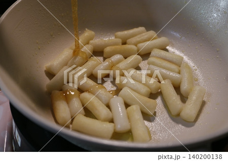 Syrup Drizzled Over Cooking Rice Cakes in Pan Syrup Drizzled Over Cooking Rice Cakes in Pan 140200138