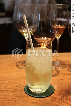 Cocktail Glass with Straw on Wooden Table 140200202
