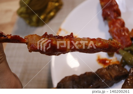 Saucy Skewered Meat Close-Up Saucy Skewered Meat Close-Up 140200261