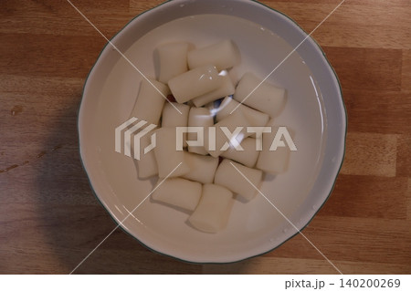 Bowl of White Cylindrical Food in Water Bowl of White Cylindrical Food in Water 140200269